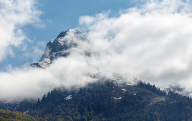 A mountain covered in clouds and snow