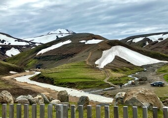 Icelandic highland landscape at Kerlingarfjöll basecamp with green land and snow