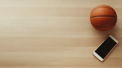 A basketball rests beside a smartphone on a wooden surface, ideal for sports or fitness-related content, social media, or lifestyle marketing