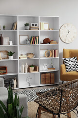 Interior of living room with bookshelf and armchairs