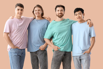 Group of young men on beige background