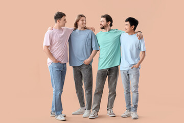 Group of young men on beige background