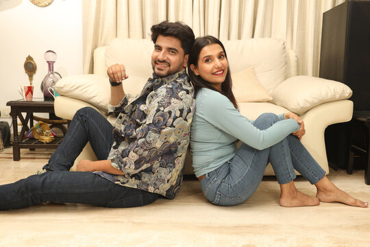 Portrait of happy young romantic couple in love enjoy resting on cozy couch sofa in living room. happy moment, harmonic relationships, love making care and enjoying weekend time together, copy space