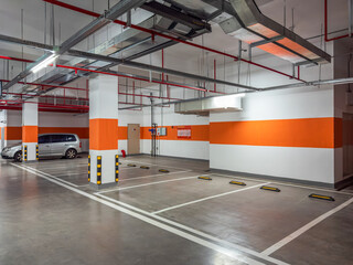 Modern Parking Garage Featuring Bright Orange Accents and Open Spaces