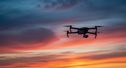 Drone Silhouette Against Vibrant Sunset Sky: Aerial Photography at Golden Hour