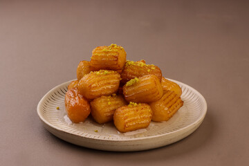 Tulumba or Balah El Sham is Turkish Fried Choux Pastry Dough With Simple Syrup. 