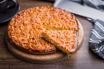 Sweet almond pie on wooden table.