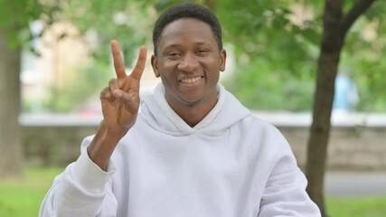 African Man Showing Peace Sign Outdoors, Portrait