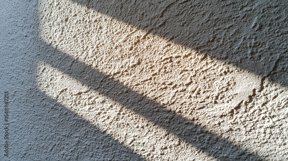 Poster close up detailed texture of rough beige wall surface with natural light and shadows creating warm a