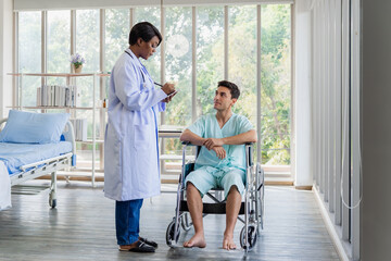 The patient journey begins with an accident, a man falls and is later seen in a wheelchair consulting with his doctor. A disabled man in a wheelchair looking out a hospital window