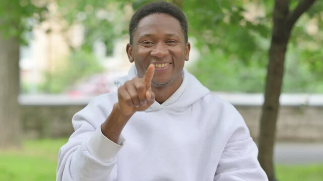 African Man Pointing Directly at Viewer Outdoors, Portrait