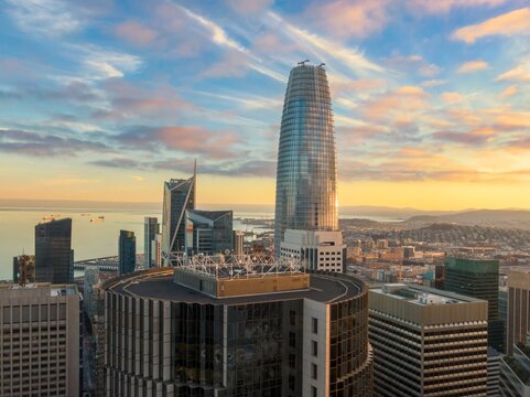San Francisco, USA: An aerial view of the city skyline at sunset, featuring the Salesforce Tower and other skyscrapers. The photo captures the urban landscape.