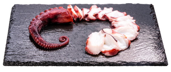 Closeup,Raw Tentacles of octopus on black plate on white background, kraken tentacles with suckers isolate on white with clipping path PNG File.
