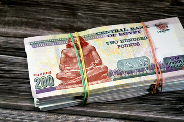 A Stack and pile of Egypt money thousands of Pounds currency banknotes bills of 200 EGP LE,...