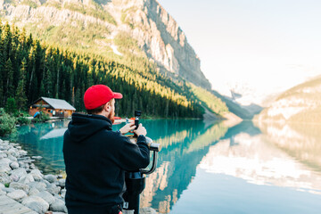 Young man vlogging at Lake Louise in Banff National Park