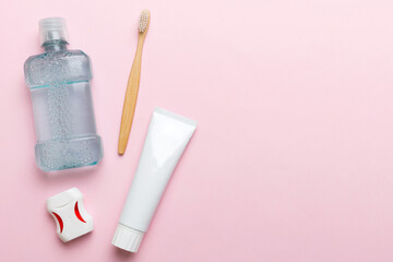 Mouthwash and other oral hygiene products on colored table top view with copy space. Flat lay....