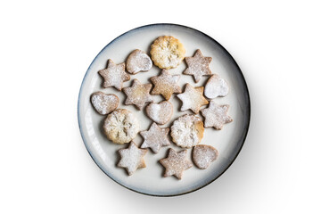 A plate of assorted star and heart-shaped cookies dusted with powdered sugar.