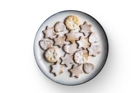 A plate of assorted star and heart-shaped cookies dusted with powdered sugar.