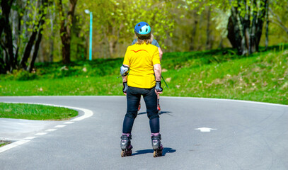 woman on roller skates rides in the Park
