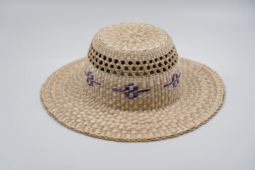 Antique straw hat made of natural materials isolated on white background