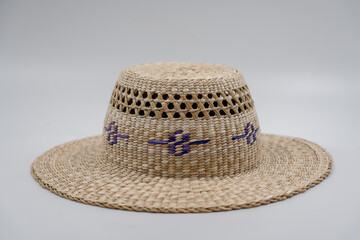 Antique straw hat made of natural materials isolated on white background