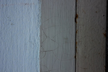 Close-up texture of old, cracked paint on a wooden and wall surface. An abstract vintage and grunge...