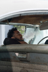 Man seating in the vintage car