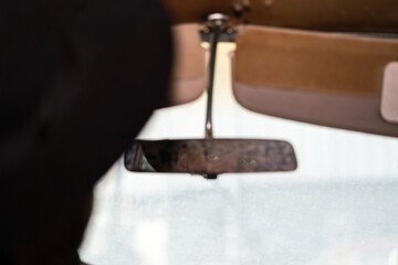 Reflection of the eye of man in the back mirror of the car