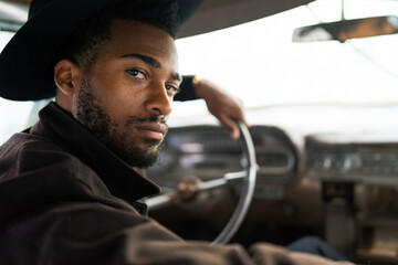 Man seating in the vintage car
