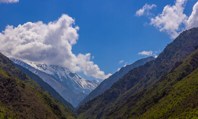 Majestic snow-capped mountains under serene clouds in Kyrgyzstan
