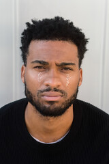 Man with glitter tears looking at camera