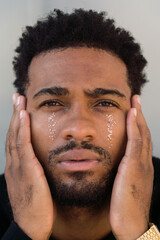 Man with glitter tears looking at camera