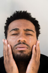 Man with glitter tears looking up
