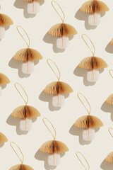 Christmas Ornaments from Paper as repeat pattern, creative New Year minimal trend flat lay, winter seasonal holiday decorations as mushrooms, white beige brown color. Happy holiday, Merry Christmas