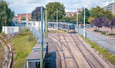 Power supply communications for tram Tramway tracks and vehicles at a transit yard under a clear sky during daytime