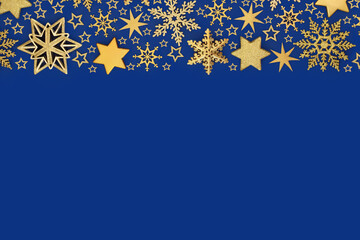 Xmas luxury bauble decorations gold stars, snowflakes, background on blue. Festive abstract design...