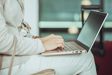 business people using laptop computer during waiting flight travel trip at the airport waiting area