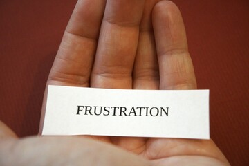Frustration subtitle or text on paper with hand and copy space.