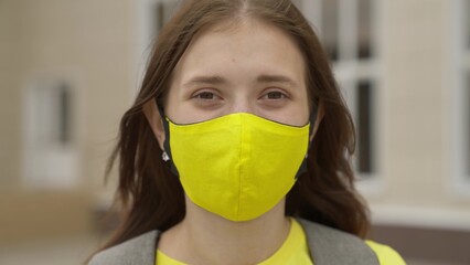 Young girl schoolgirl smiling in a protective mask, coronavirus pandemic, covid 19, safe walking...