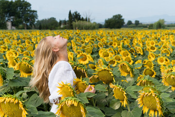 Woman in the field of sunflowers