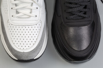 Toecaps of black and white leather classic sneakers, top view