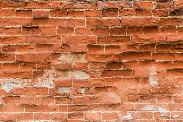 Fragment of ancient red brick wall close-up