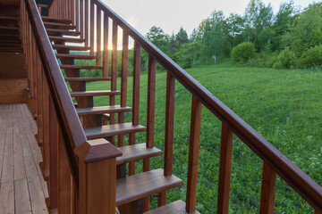 External wooden stairs of building against mountain slope at sunset
