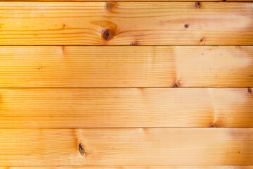 Part of indoor wall lined with horizontal wooden beams