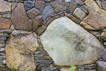 Wet retaining wall built with different stones in rainy day © An-T