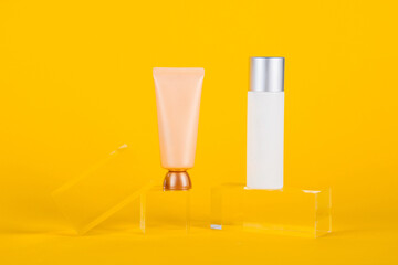 Plastic white tube for cream or lotion. Skin care or sunscreen cosmetic with stylish props on...