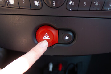 car interior, car, emergency lights in a car, a person's hand presses the emergency lights button,...