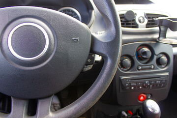 car interior, manual gearbox, hand on steering wheel, car dashboard, driver, driving a car