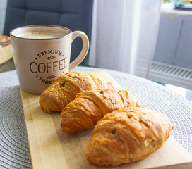 cup of coffee and croissant on the table, morning, breakfast, snack, breakfast in the kitchen,