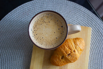cup of coffee and croissant on the table, morning, breakfast, snack, breakfast in the kitchen,